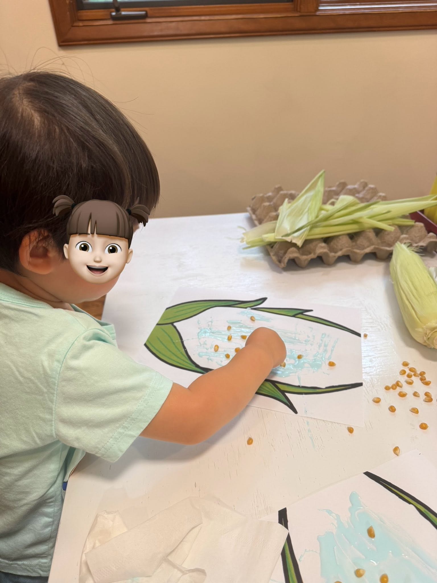 Panda Bear Childcare — child creating corn craft art project