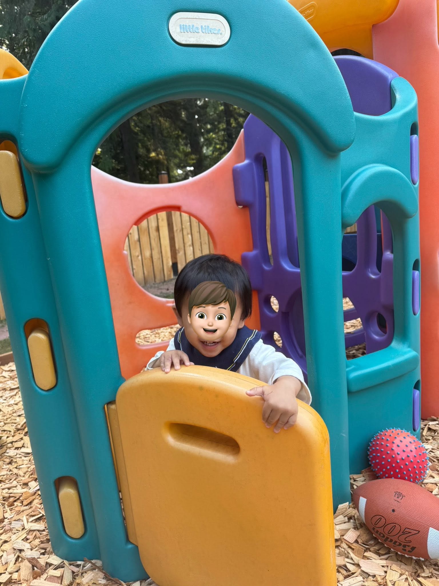 Panda Bear Childcare — toddler playing in colorful playground structure